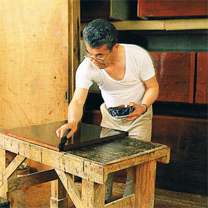 伝統工芸職人が呂塗りをしているイメージ